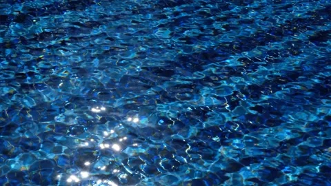 Sunlight Dancing Across Blue Tiled Swimming Pool Stock Footage 145449085