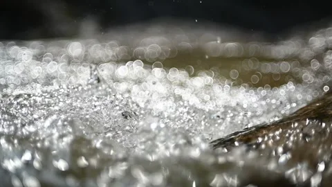Sunlight effects and bokeh on the water from a mountain stream (slow motion) Stock-Footage 219640351
