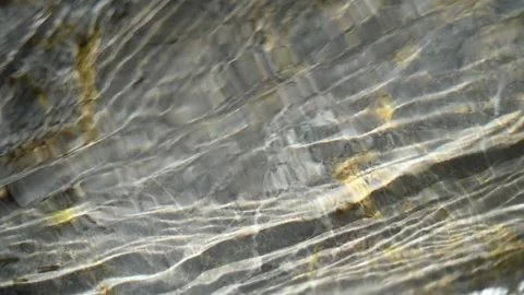 Sunlight effects of clear water that flows over rocks (slow motion, close up) Stock Footage 212737101