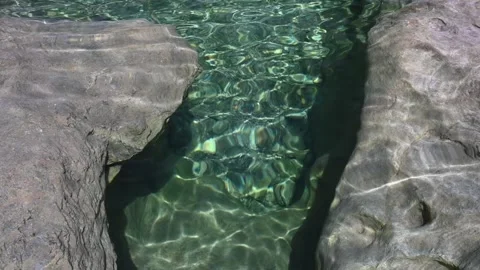 Sunlight effects in a pool between rocks (slow motion) Stock Footage 219650961