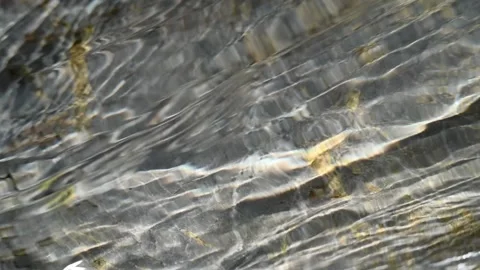 Sunlight effects of water flowing over rocks in the mountains (slow motion, clos 스톡 동영상 212736415