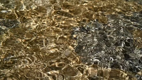 Sunlight effects on water from a mountain river in summer (slow motion) Video stock 212885242