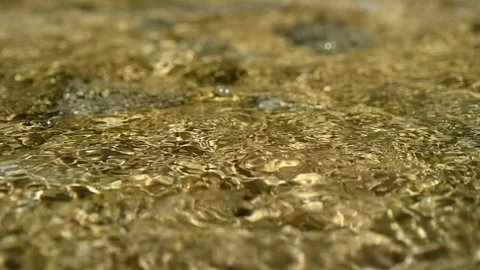 Sunlight effects on water from a mountain river in summer (slow motion, bokeh) Video stock 212885344