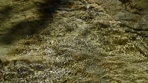 Sunlight effects of the water in a mountain riverbed (slow motion) Stock-Footage 211745437