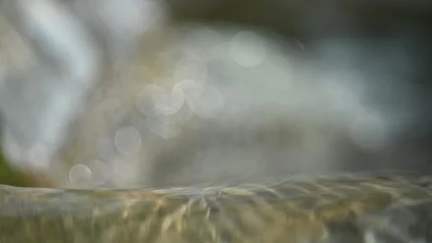 Sunlight effects in water from a rocky mountain river (slow motion, bokeh) Stock Footage 212738085