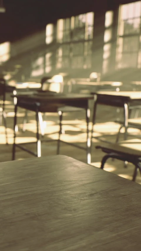 Sunlight enters classroom revealing empty desks and chairs in morning light Stock Footage 334247410