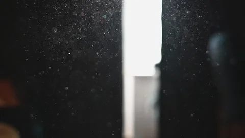 Sunlight enters through an open window illuminating dust particles floating in Stock Footage 336778825