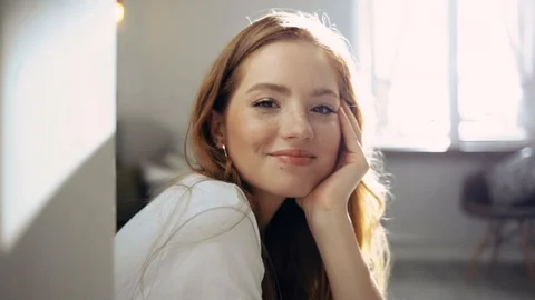 At sunlight face stylish beautiful young woman sitting look at camera smile at 스톡 동영상 115210028