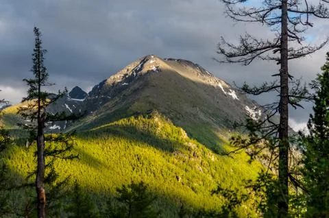 Sunlight falling on the Altai Mountains through the clouds Stock Photos