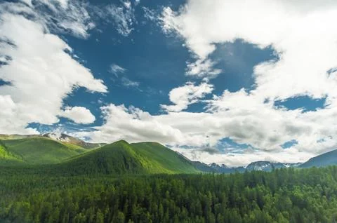 Sunlight falling on the Altai Mountains through the clouds Stock Photos