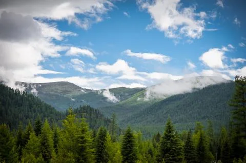 Sunlight falling on the Altai Mountains through the clouds Stock Photos