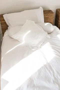 Sunlight falling on a bed Stock Photos