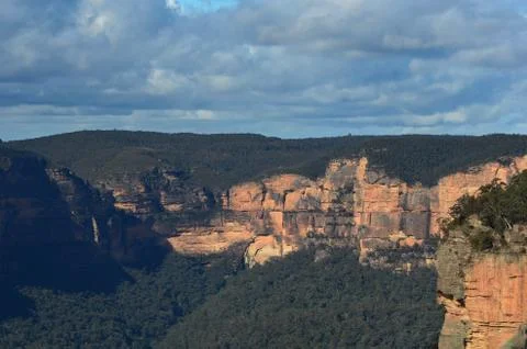 Sunlight falling on cliffs in the Blue Mountains, Australia. Stock Photos