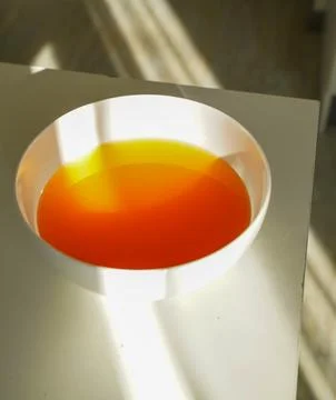 Sunlight falling on warm herbal tea. Stock Photos