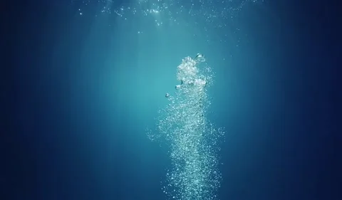 Sunlight Filtering Through Blue Water: Rising Plume of Bubbles 4K Stock Footage 339275155