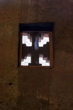 Sunlight Filtering Through a Cross-Shaped Window in Lalibela Photos