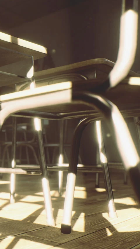 Sunlight filtering through empty classroom chairs on a quiet afternoon Stock Footage 335237015