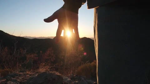 Sunlight filtering through a man's hand at sunset Stock Footage 259403430