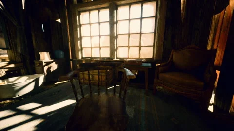 Sunlight filters through dusty windows illuminating rustic interior space Stock Footage 312573189
