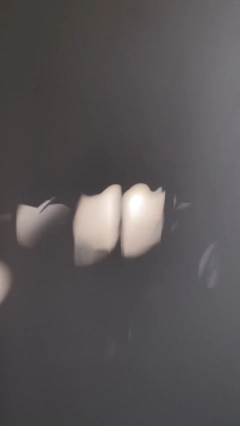 Sunlight filters through a window, casting an abstract light show on a dark.. Stock Footage 273574388