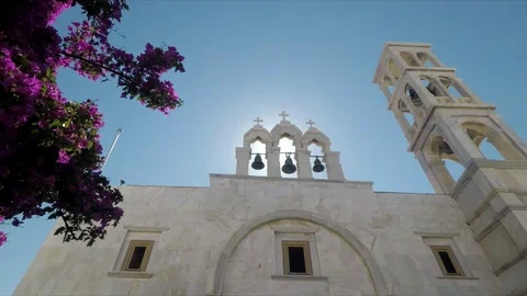 Sunlight flares through bell tower of orthodox church in Santorini, Greece. Stock Footage 116455206