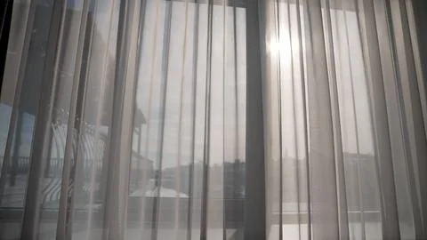 Sunlight gently filtering through sheer curtains Stock Photos
