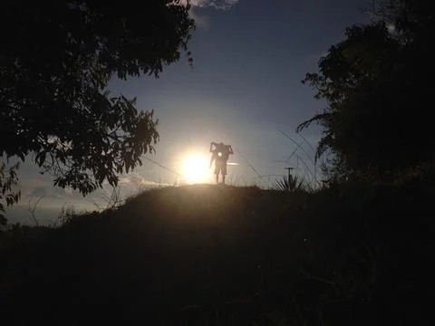 Sunlight getting through the clouds and mountains at sunset Stock Photos