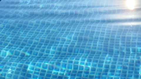 Sunlight Glare Refracted Over Rippling Blue Swimming Pool Water Surface Stock Footage 344055612