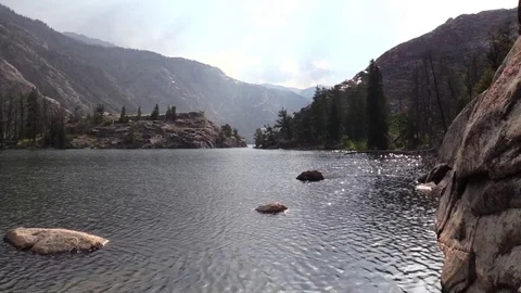 Sunlight gleaming on mountain lake Stock Footage 79006688