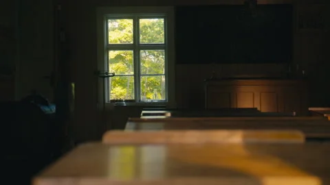 Sunlight Gliding Across Old School Desks in a Quiet Historic Classroom Interior Stock Footage 338161133