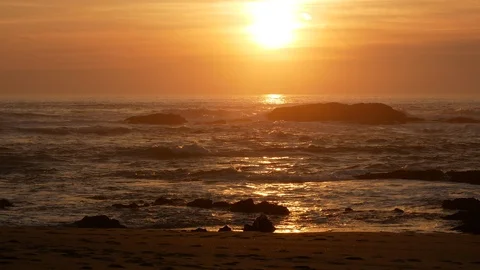 Sunlight glinting on ocean at sunset on the beach, beautiful golden light Stock Footage 103121676