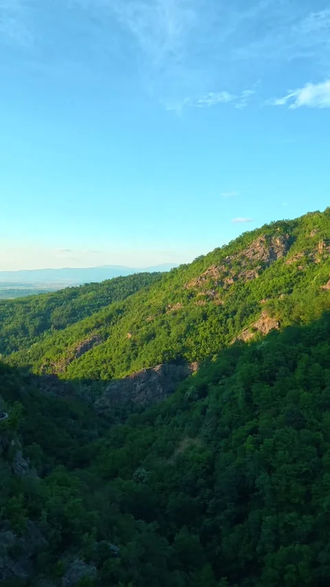 Sunlight glints off rocky ridges. Sokolica rock, Serbia. Vertical Stock Footage 341132572