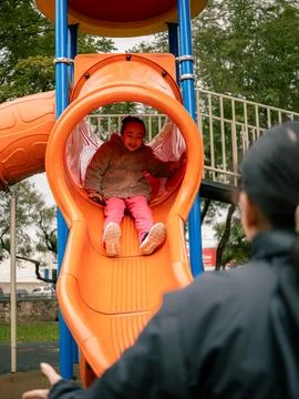 Sunlight glints off the smooth slide surface Stock Photos