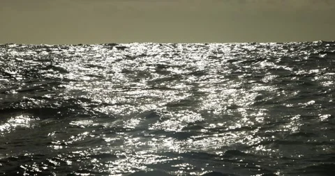 Sunlight Glittering Across Rolling Ocean Surface Stock Footage 341639681