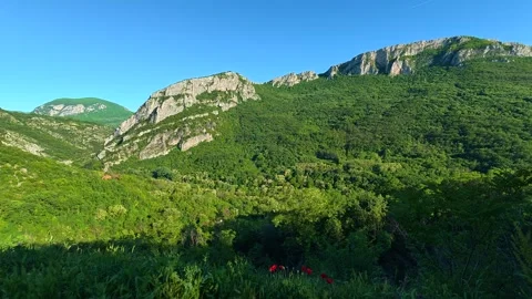 Sunlight glows on forested hills and rocky peaks. Sicevo Gorge, Serbia. Stock Footage 337051762