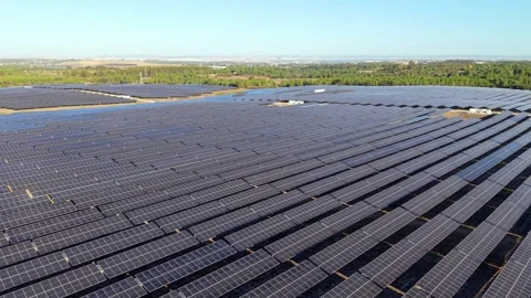 Sunlight glows over organized rows of photovoltaic panels Video stock 346062799
