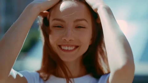 At sunlight happy face young sunshine woman look at camera stand in the city Stock Footage 157644150