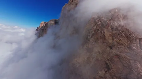 Sunlight highlighting dramatic rocky landscape, casting shadows across weathered Stock Footage 304525700