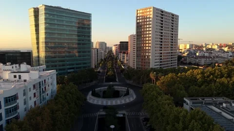 Sunlight highlights skyscrapers and greenery in urban center; Parque das Nacoes Video stock 346071385