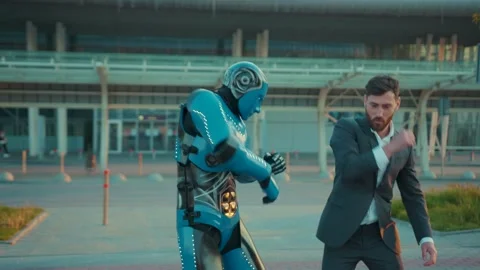 At sunlight humanoid robot having fun dance with man funny smilling on street in Stock Footage 133308155
