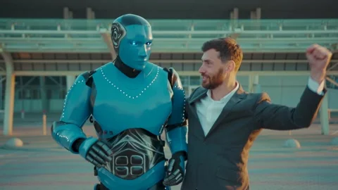At sunlight humanoid robot having fun dance with man funny smilling on street in Stock Footage 133631161