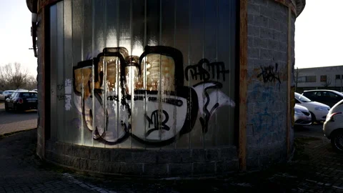 Sunlight Illuminates Graffiti Sprayed on Glass Window of Parking Lot Kiosk 4K Stock Footage 200880516