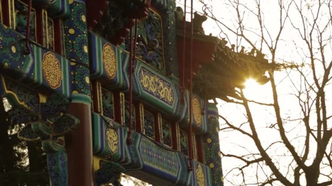 Sunlight Illuminates Ornate Temple Gate at Lama Temple in Beijing, China Stock Footage 345830453