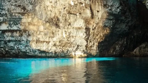 Sunlight Illuminating Ancient Cave Walls and Lush Vine Growth in Kefalonia Stock Footage 328306901