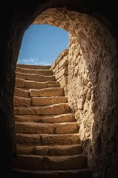 Sunlight Illuminating Ancient Stone Steps Leading out of a Dark Passageway .. Stock Photos