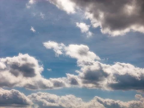 Sunlight Illuminating the Edges of Soft Clouds Stock Photos