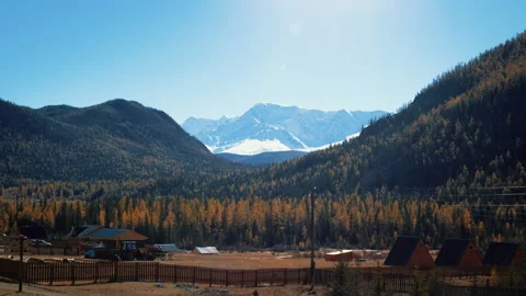 Sunlight illuminating snow capped mountain range Video stock 282975196