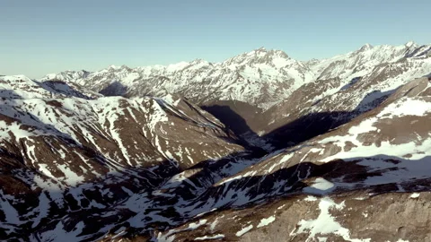 Sunlight illuminating snow capped Pyrenees mountain peaks, revealing dramatic 스톡 동영상 306710287