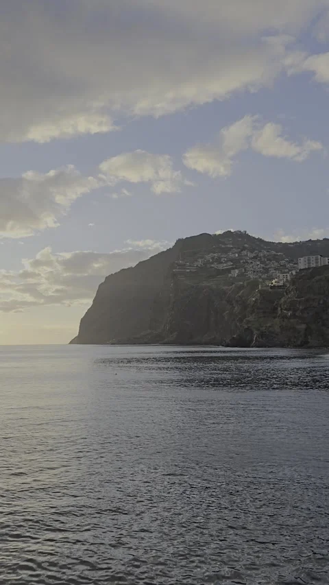 Sunlight melts over Câmara de Lobos and the Atlantic horizon.  Video stock 310024743