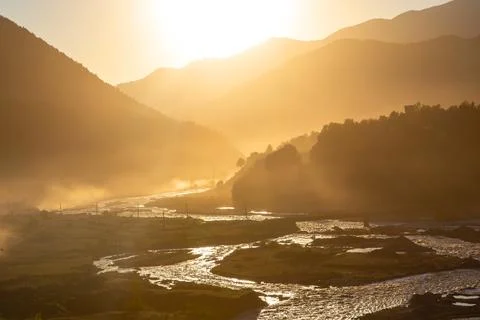 Sunlight in the mountains against the backdrop of a mountain river in Georgia Stock Photos
